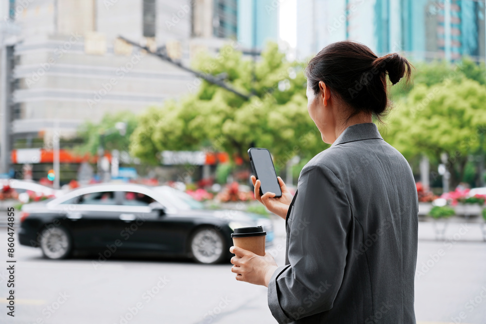 Businesswoman on Smartphone in Urban Setting Businesswoman on Smartphone in Urban Setting