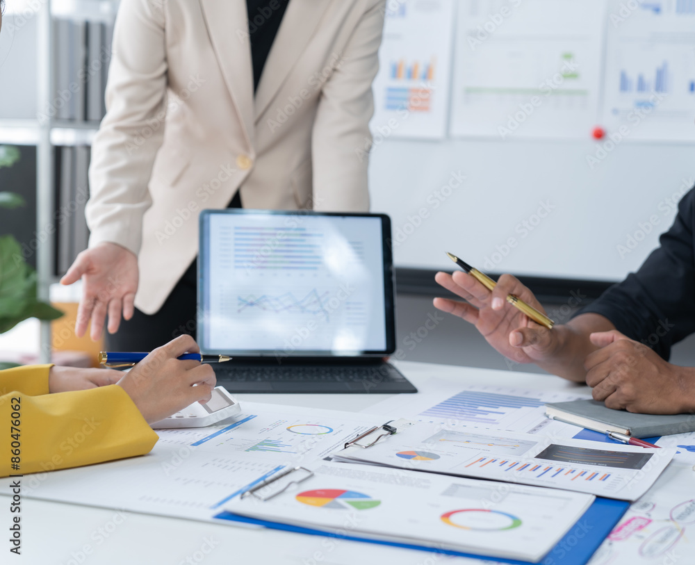 A photograph of a male and female employee's hands as they meet in an office, pens and laptops at the ready as they consult on business matters. A photograph of a male and female employee's hands as they meet in an office, pens and laptops at the ready as they consult on business matters.