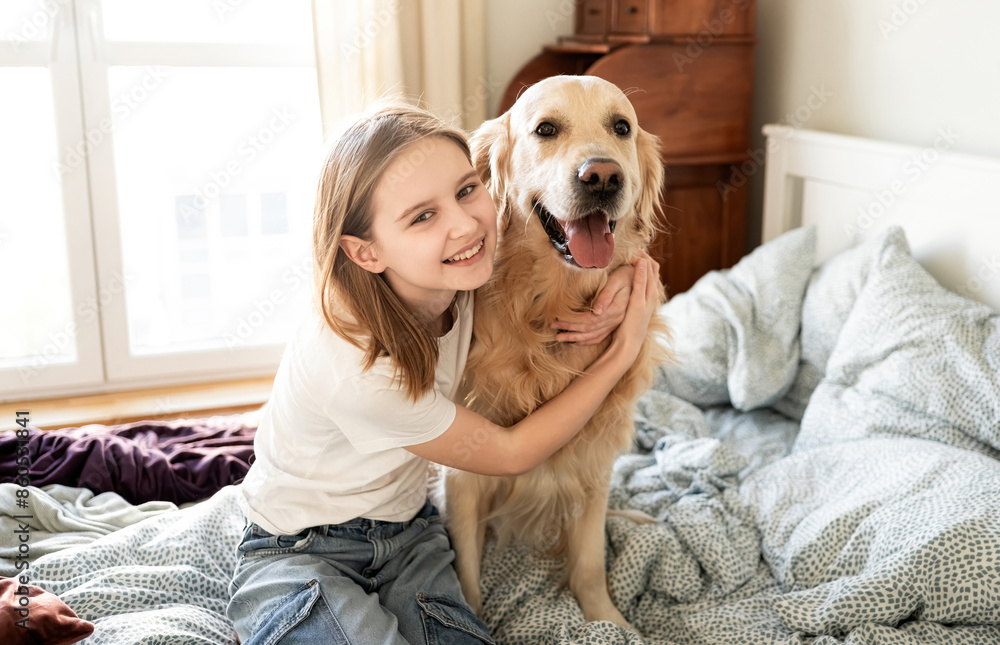 Joyful Little Girl Hugging Golden Retriever Dog And Looking Into The Cameara Joyful Little Girl Hugging Golden Retriever Dog And Looking Into The Cameara