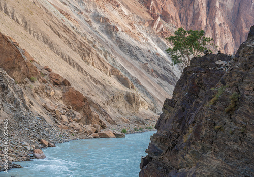 A majestic river flows through a canyon nestled between two towering mountains, Trek to Puktal Monastery, Zanskar
