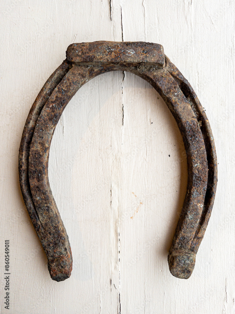 Old horseshoe on wooden background Old horseshoe on wooden background