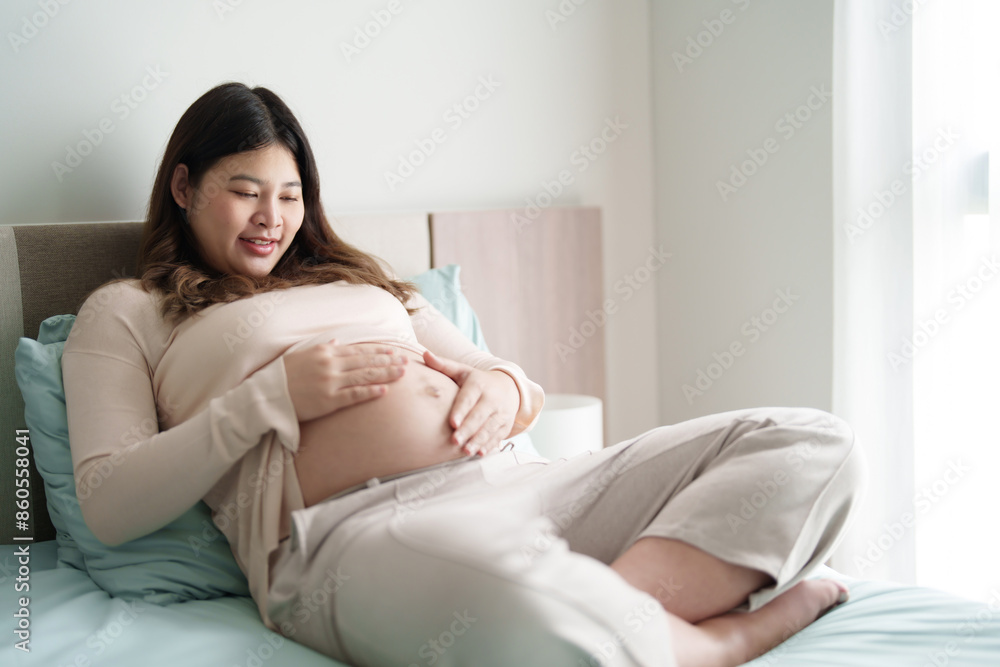 Pregnant woman hand touch on belly caring about her baby health at home Pregnant woman hand touch on belly caring about her baby health at home