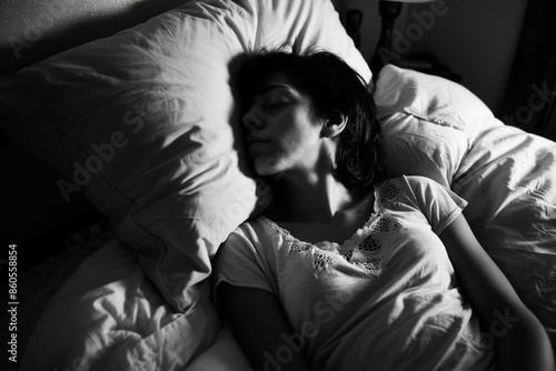 A woman is sleeping on a bed with a pillow