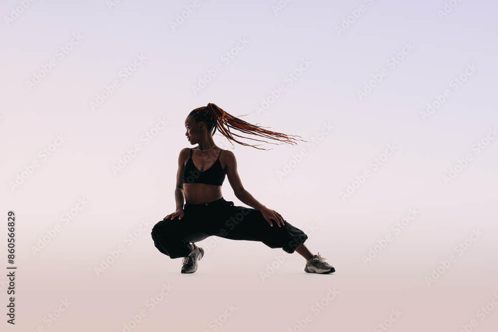Confident Gen z dancer flexing her flexibility in white studio Confident Gen z dancer flexing her flexibility in white studio