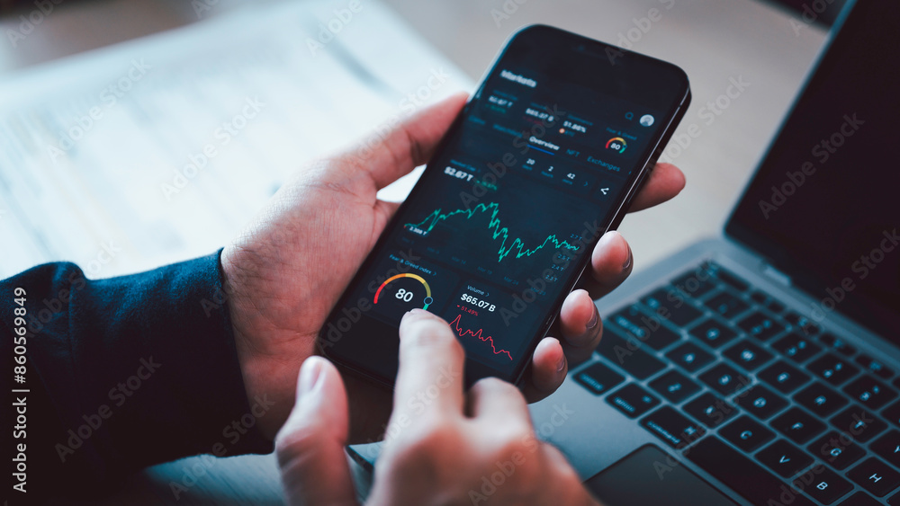 Investors analyze the data stock market index via smartphone screen to trade the stock chart for planning investments take profit, trade stock exchange market and cryptocurrency data, financial.