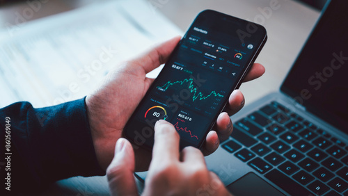 Obraz na płótnie Investors analyze the data stock market index via smartphone screen to trade the stock chart for planning investments take profit, trade stock exchange market and cryptocurrency data, financial. w salonie