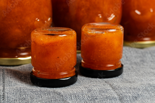 Jars with freshly prepared apricot jam. Close up.