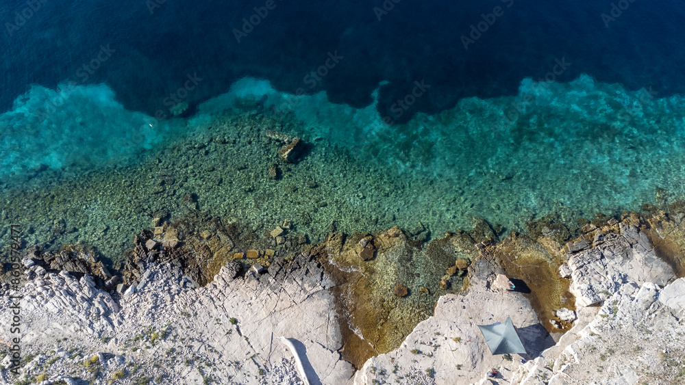 drone view of sun sail on the Mediterranean coast of the island Zirje in Croatia