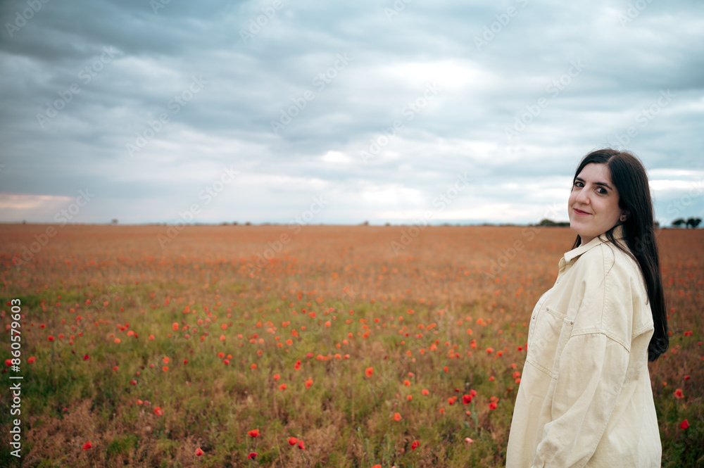 A girl enjoys the poppy field at sunset A girl enjoys the poppy field at sunset