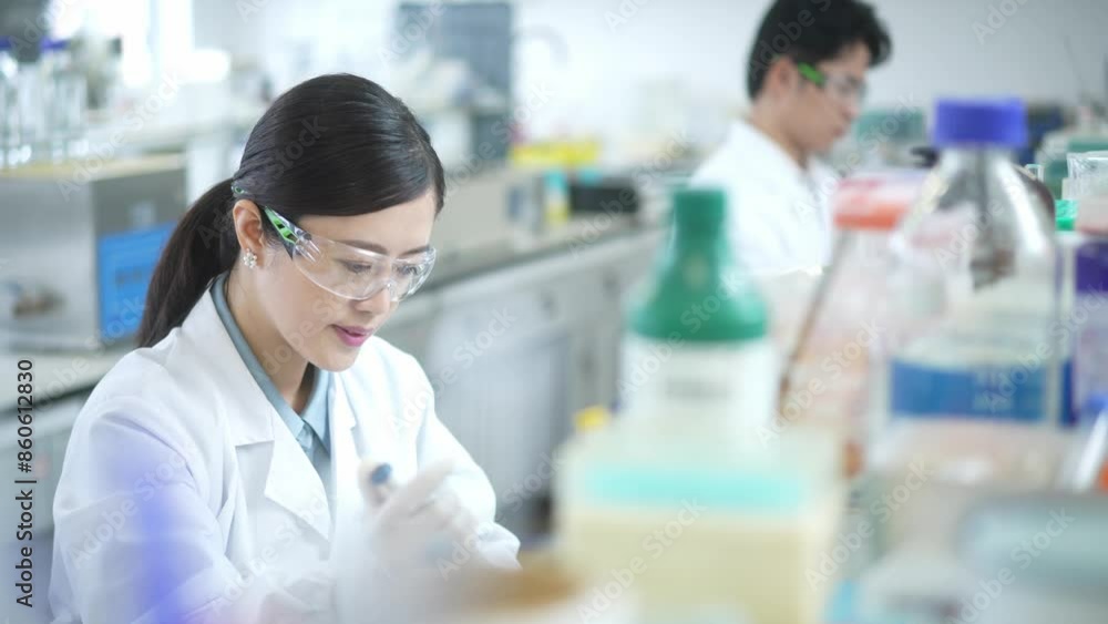 woman doctor using pipette in lab woman doctor using pipette in lab