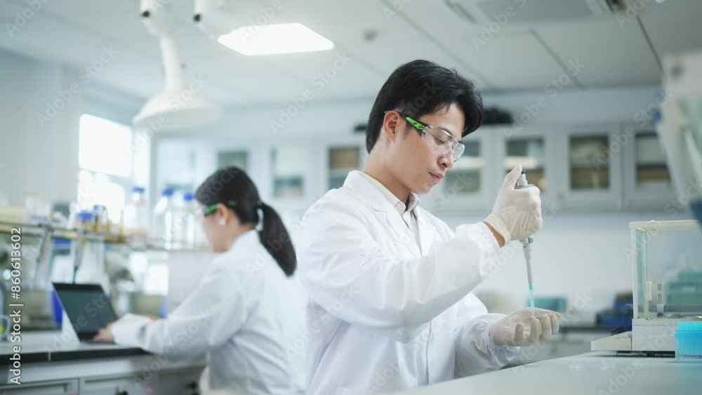man doctor using pipette in lab man doctor using pipette in lab