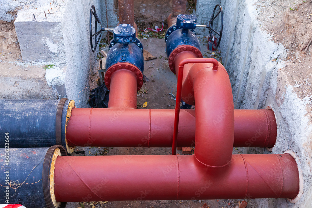 A system of new large diameter water pipes with insulation and valves in the ground. A system of new large diameter water pipes with insulation and valves in the ground.