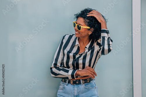 Vászonkép middle-aged woman on the street wearing sunglasses