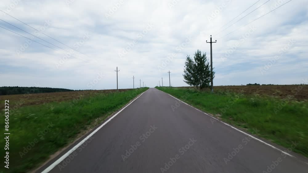 Pov view on asphalt road between fields in countryside. Pov view on asphalt road between fields in countryside.