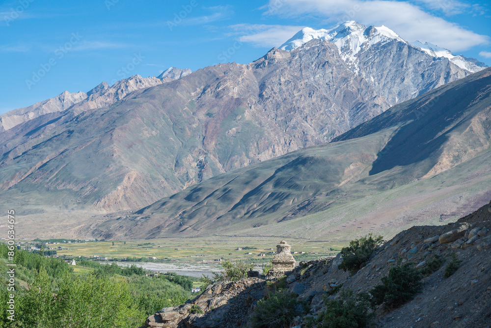In the background, there is a blue sky over a snowy mountain, Zanskar, Himalayas In the background, there is a blue sky over a snowy mountain, Zanskar, Himalayas
