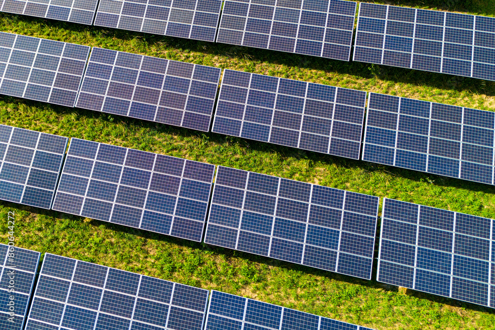 aerial view of solar panels on solar farm during a sunny day. modern photovoltaic solar battery panels. Renewable energy concept