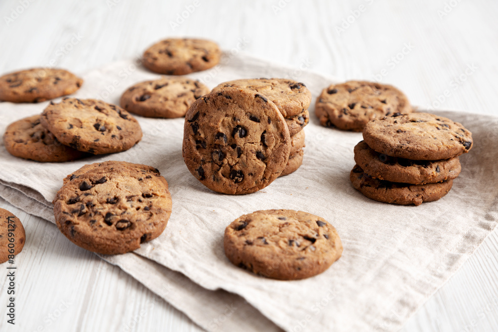 Homemade Gooey Chocolate Chip Cookies on a white wooden background, low angle view. Homemade Gooey Chocolate Chip Cookies on a white wooden background, low angle view.