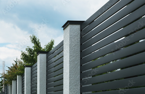 A fragment of a corrugated board fence on a private plot