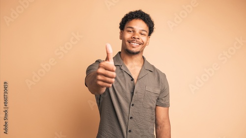 Bild auf Leinwand Smiling man making thumbs up gesture and nodding to show approval