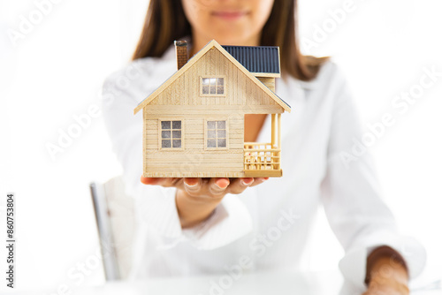 Small toy house in hands. Your new house
