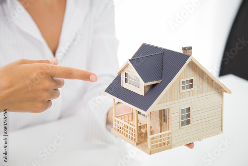 Small toy house in hands. Your new house