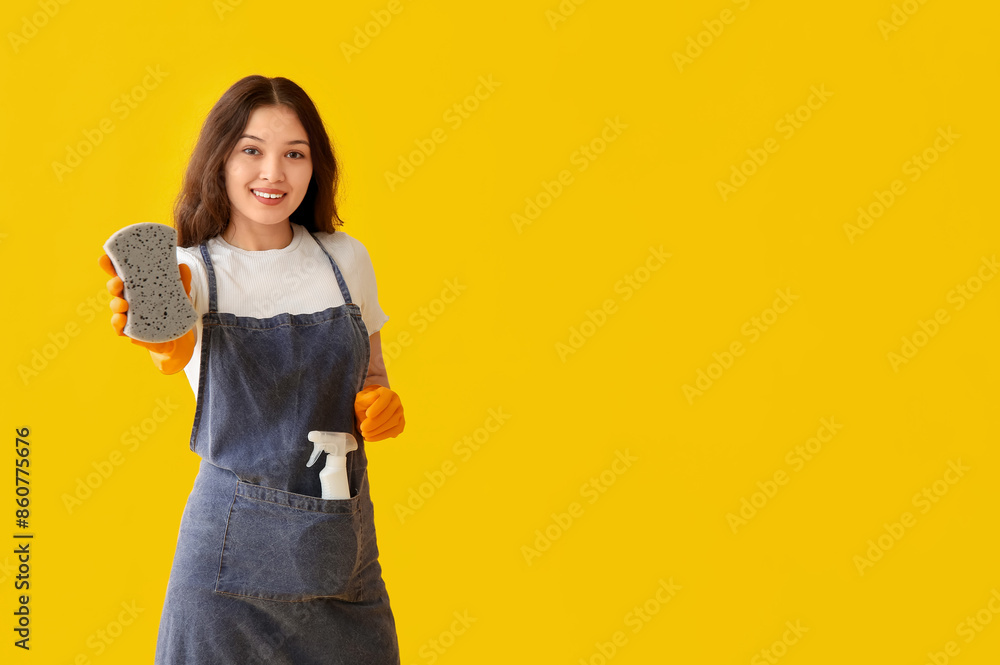 Young woman with sponge on yellow background Young woman with sponge on yellow background