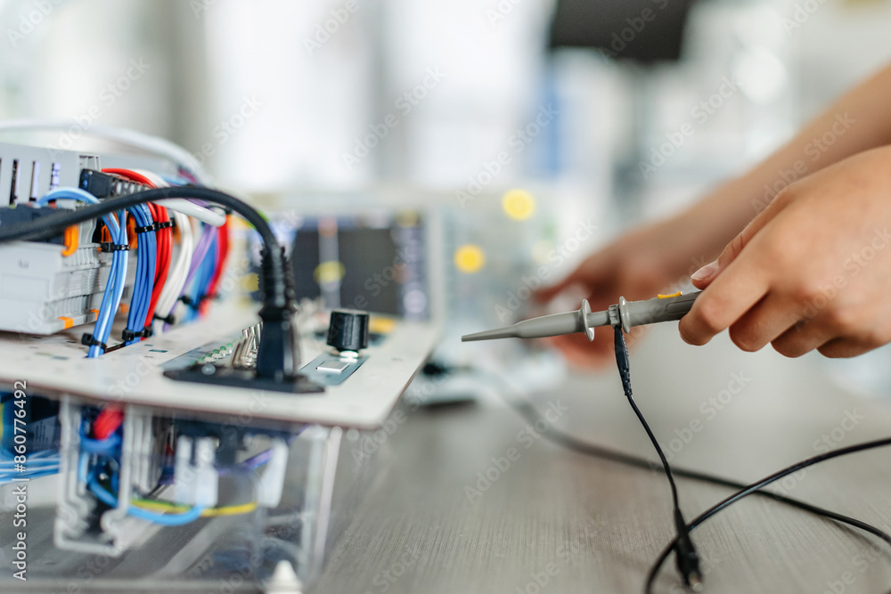 Working on circuit board, building robot in after-school robotics club. Children learning robotics in Elementary school. Working on circuit board, building robot in after-school robotics club. Children learning robotics in Elementary school.