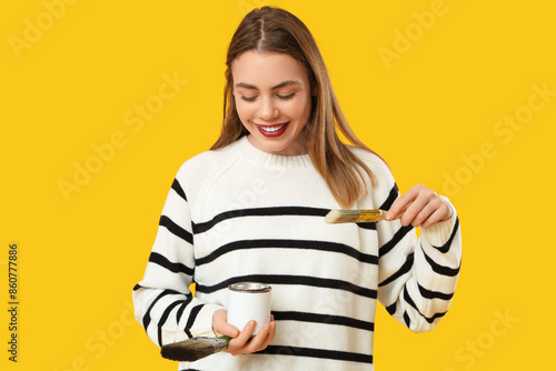 Young woman with can of pai...
