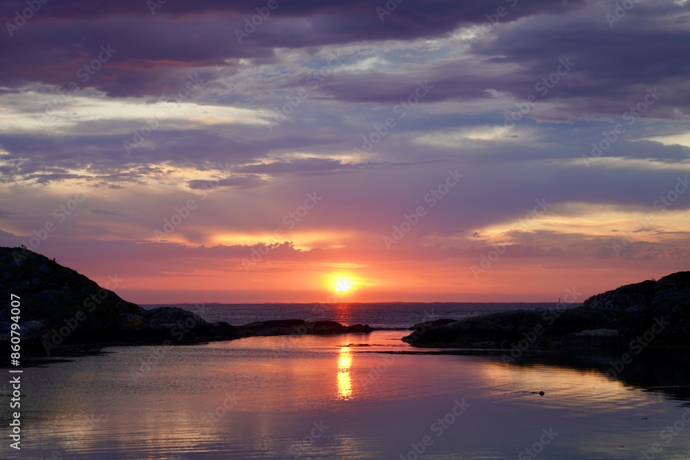 Fototapeta premium Scenic view of sunset colors is displayed over the ocean outside Kristiansund, Norway.