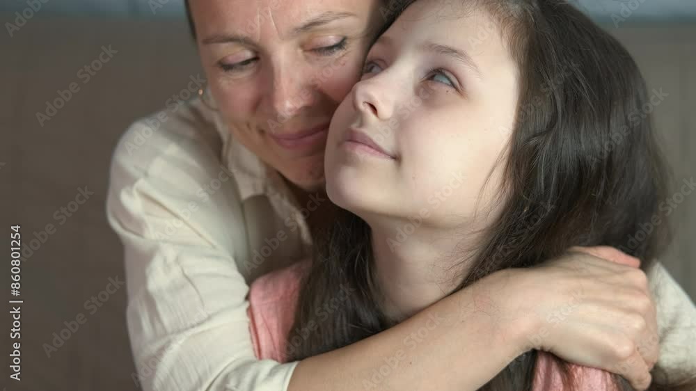 Hugging young mother. A view of hugging mother with child resting on the sofa indoor. Hugging young mother. A view of hugging mother with child resting on the sofa indoor.