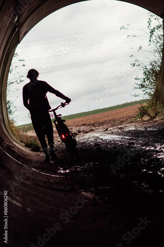 man walking next to his bike