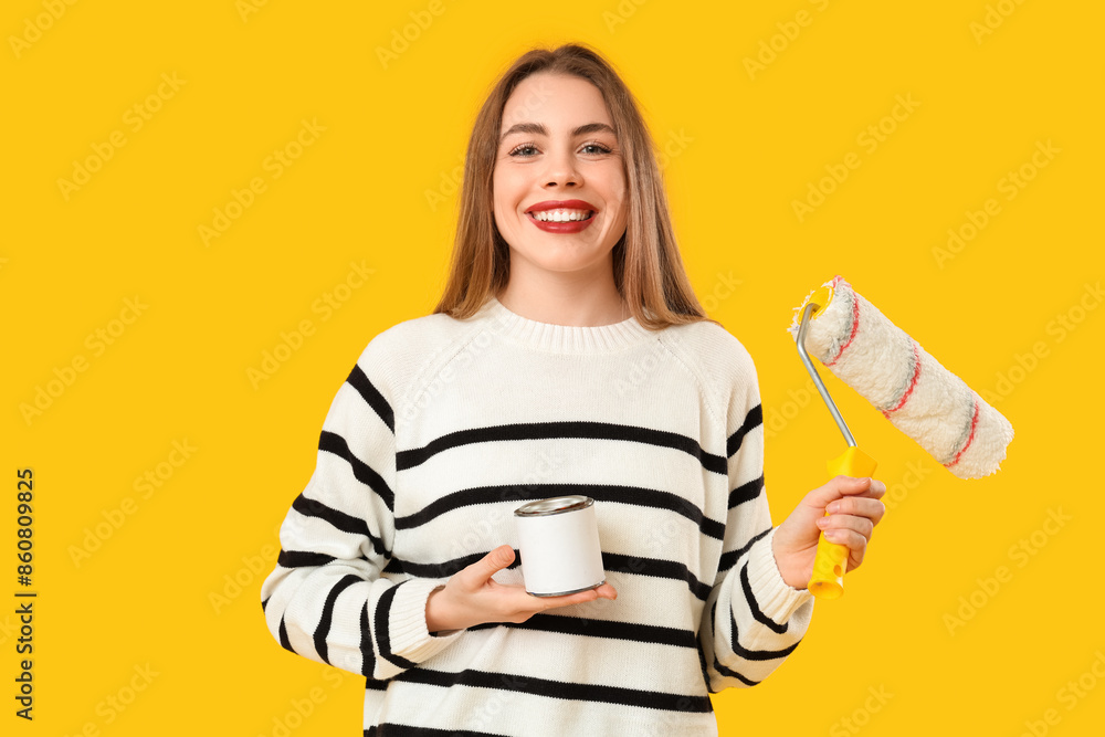 Young woman with can of paint and roller on yellow background Young woman with can of paint and roller on yellow background