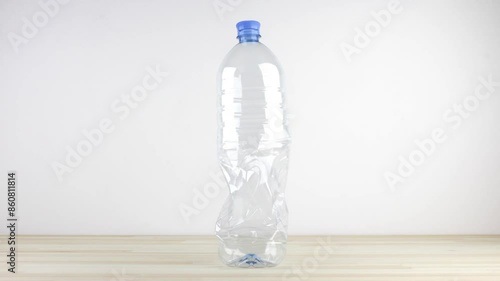Empty plastic bottle folding down and unfolding back seamless loop cycle stop-motion. Recycle concept
