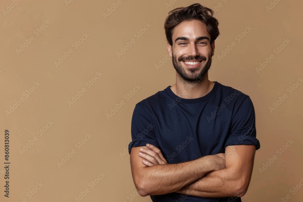 Man with crossed arms in frontal position isolated on beige background Man with crossed arms in frontal position isolated on beige background