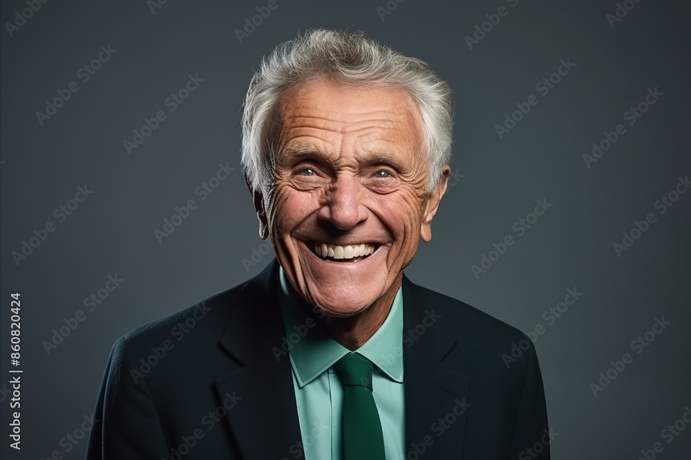 Portrait of a happy senior businessman posing over grey background. Looking at camera. Portrait of a happy senior businessman posing over grey background. Looking at camera.