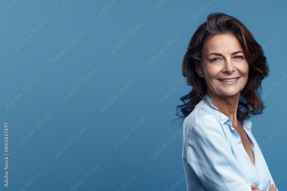Smiling 60-Year-Old Woman on Blue Banner - Senior Portrait Photography - Concept of Ageless Beauty and Confidence Smiling 60-Year-Old Woman on Blue Banner - Senior Portrait Photography - Concept of Ageless Beauty and Confidence