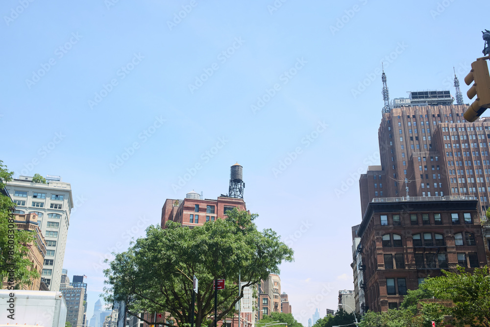Naklejka premium City street scene with blue sky. Photograph.