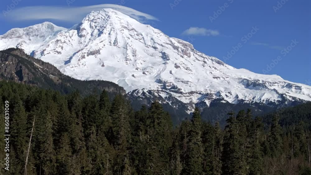 Majestic Snow-Covered Mountain with a Clear Blue Sky Majestic Snow-Covered Mountain with a Clear Blue Sky