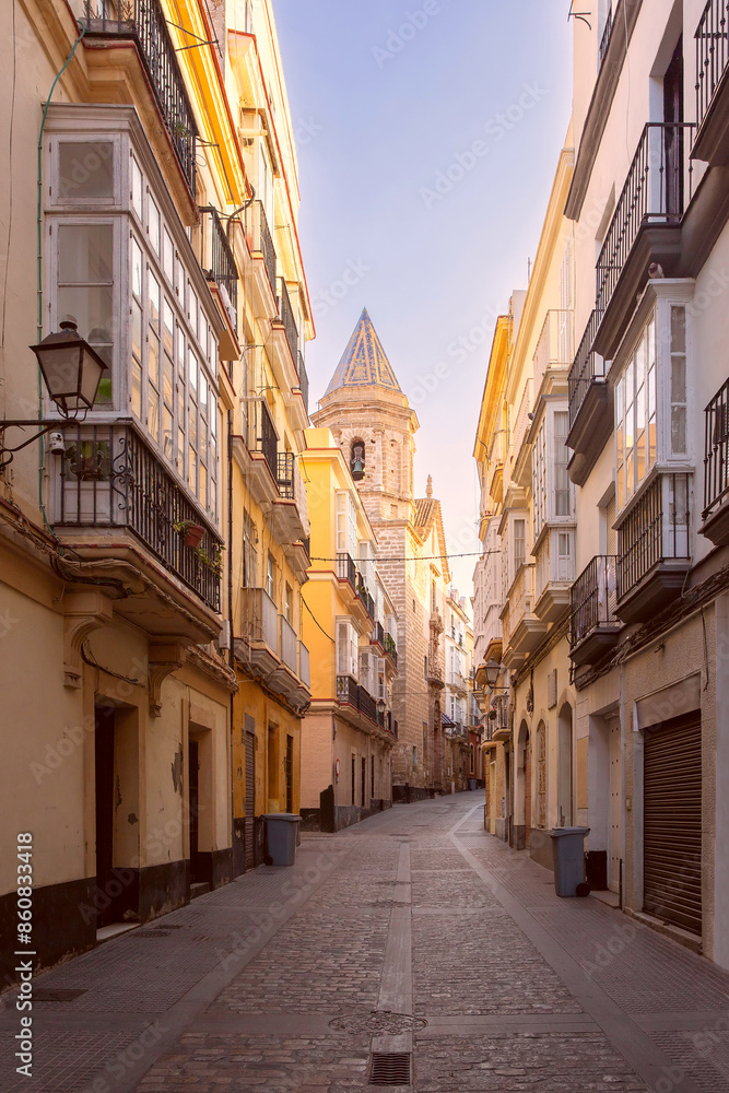 View of a deserted old narrow cobbled street early in the morning. Cadiz. Spain. View of a deserted old narrow cobbled street early in the morning. Cadiz. Spain.