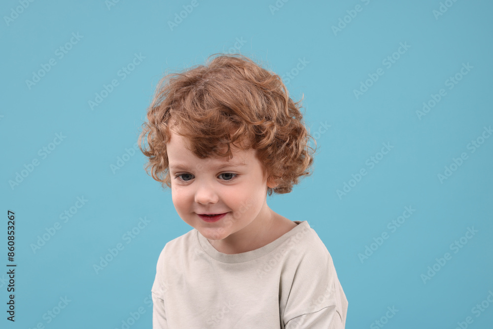 Portrait of cute little boy on light blue background Portrait of cute little boy on light blue background