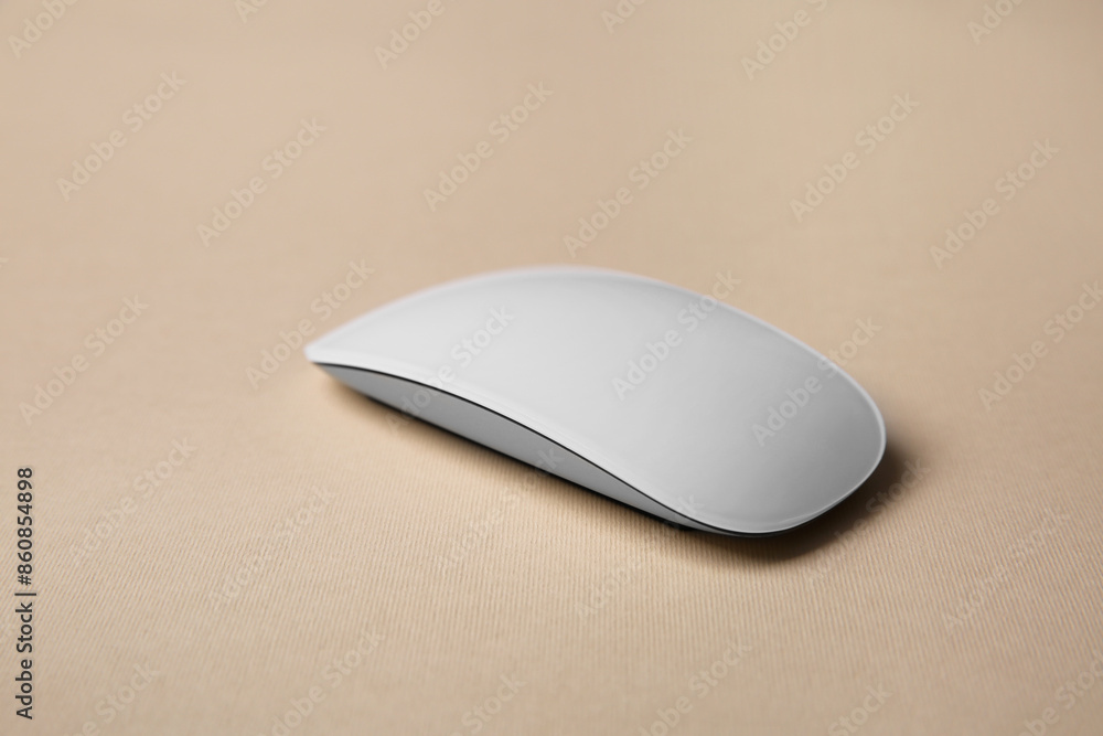 One wireless mouse on beige background. Space for text One wireless mouse on beige background. Space for text