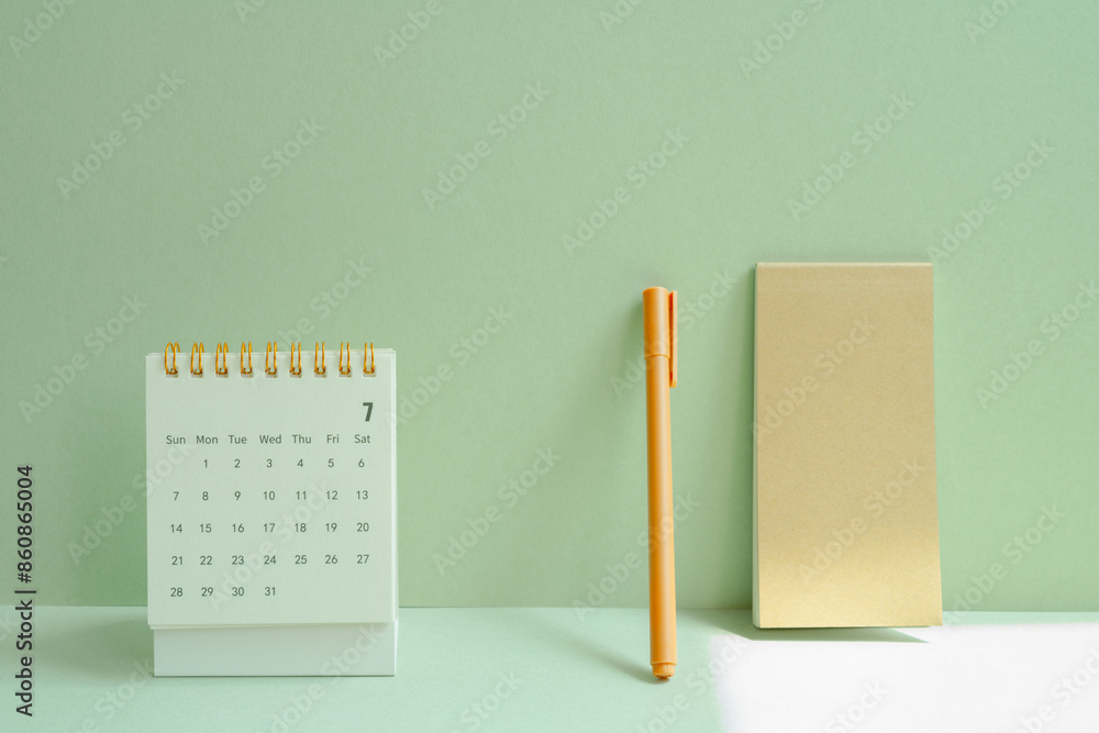 Calendar and notepad, pen for schedule, business, vacation plan on mint green desk background