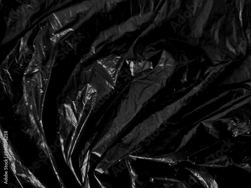 Transparent plastic wrap on the black background. Clean blank texture overlay effect template. Isolated wrinkle surface branding mock-up.