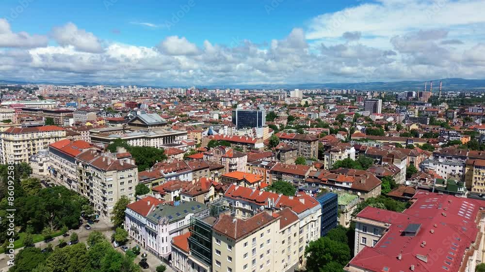Reveal aerial shot of Sofia, Bulgaria. Drone flying over the city center, facing northeast, a sunny summer day, with beautiful white clouds in the blue sky. An East European capital city Reveal aerial shot of Sofia, Bulgaria. Drone flying over the city center, facing northeast, a sunny summer day, with beautiful white clouds in the blue sky. An East European capital city