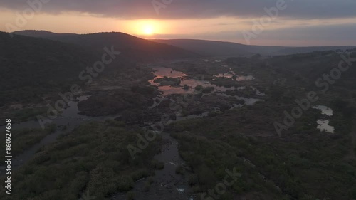 This panoramic drone journey soars over the awakening Komati River, showcasing the raw beauty of South Africa's wilderness. Sunrise. photo