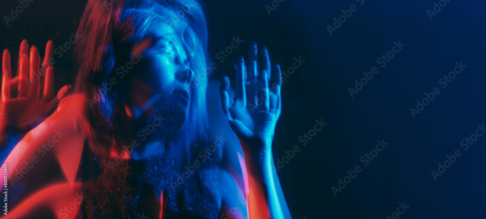 © golubovy - Anxiety disorder. Defocused silhouette. Depressed worried woman mental health mixed neon blue red light color out of focus double exposure free space. © golubovy - Anxiety disorder. Defocused silhouette. Depressed worried woman mental health mixed neon blue red light color out of focus double exposure free space.