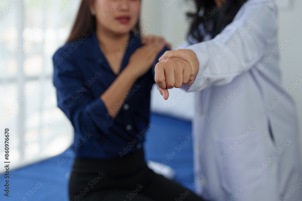 Fototapeta premium Female patient who has a problem with body aches due to fatigue from work. Retired doctor inquires about pain, gives treatment, medicine and advice Health examination in clinic.