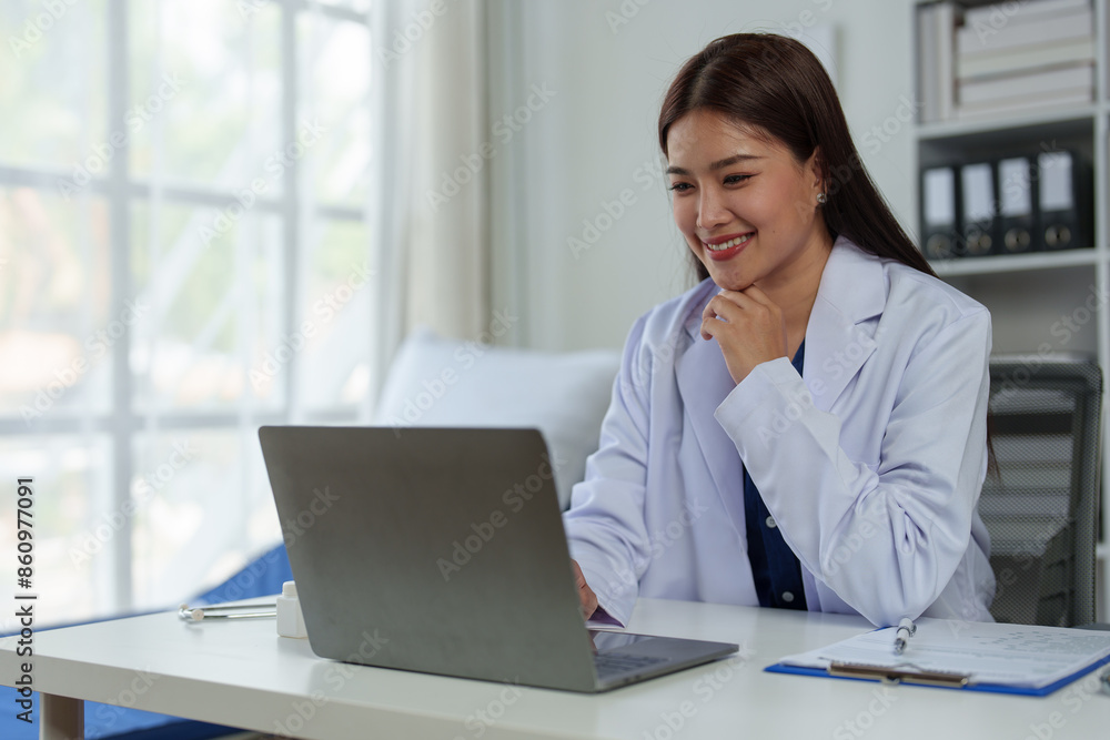 Expert Asian female doctor Professional and dedicated woman is working and reading medical research results on her laptop, studying medicine in office at hospital. Expert Asian female doctor Professional and dedicated woman is working and reading medical research results on her laptop, studying medicine in office at hospital.