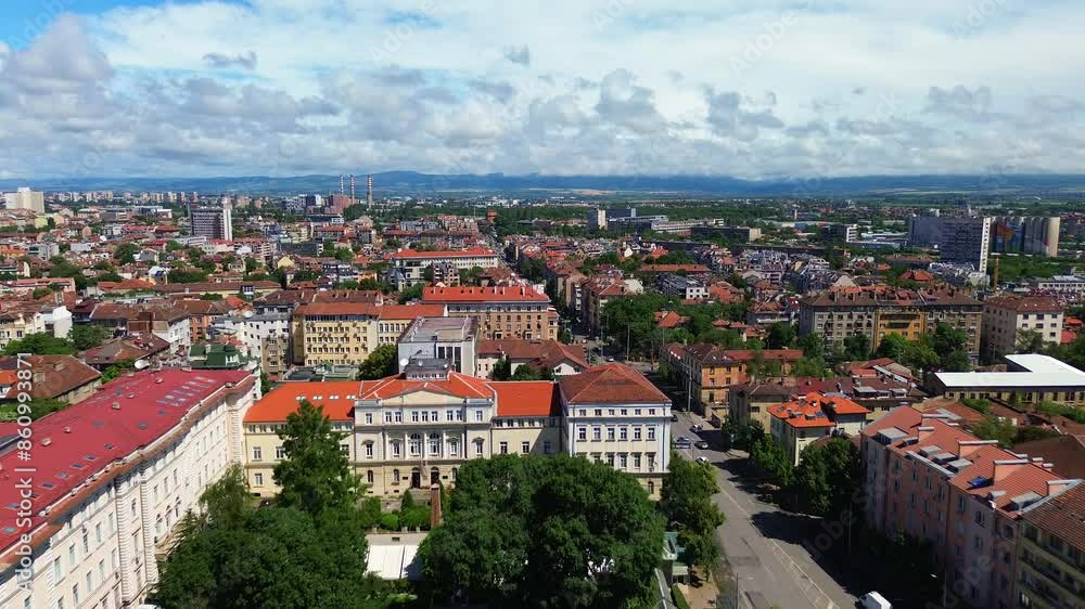 Establishing drone shot of Sofia, Bulgaria. East European capital city with classical architecture, old buildings and lots of trees between them. Vasil Levski Boulevard, on a sunny morning Establishing drone shot of Sofia, Bulgaria. East European capital city with classical architecture, old buildings and lots of trees between them. Vasil Levski Boulevard, on a sunny morning