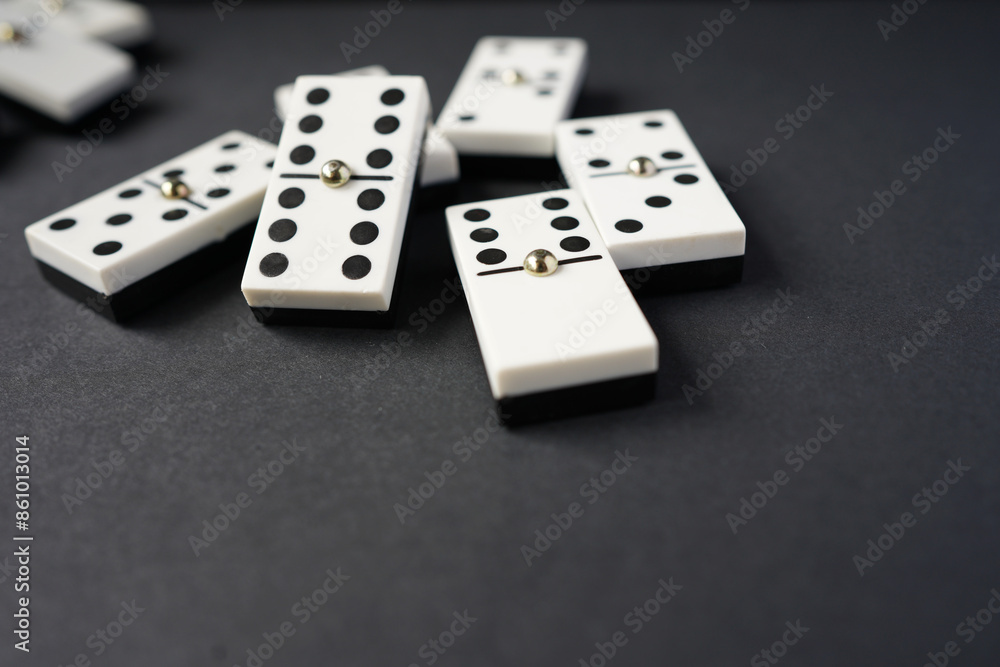 white domino blocks on black background. There are some benefits of playing domingo; helps to develop critical thinking skills, bond with families and social groups, reduces stress, improve memory. white domino blocks on black background. There are some benefits of playing domingo; helps to develop critical thinking skills, bond with families and social groups, reduces stress, improve memory.